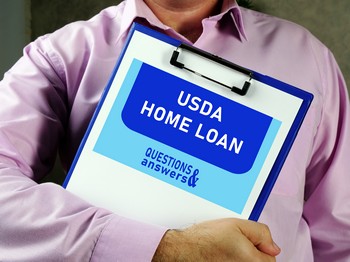A man holding a clipboard labeled "USDA Home Loan," with a visible section for questions and answers